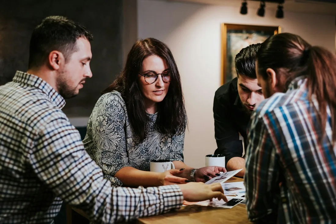 Management team reviewing business documents together