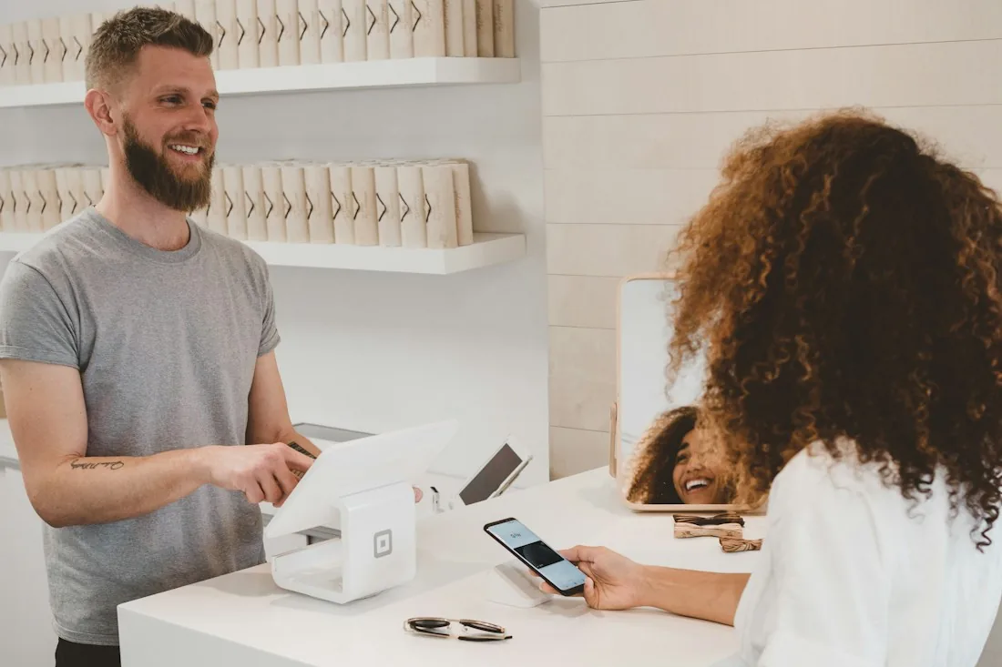 Shop assistant serving a customer at a counter