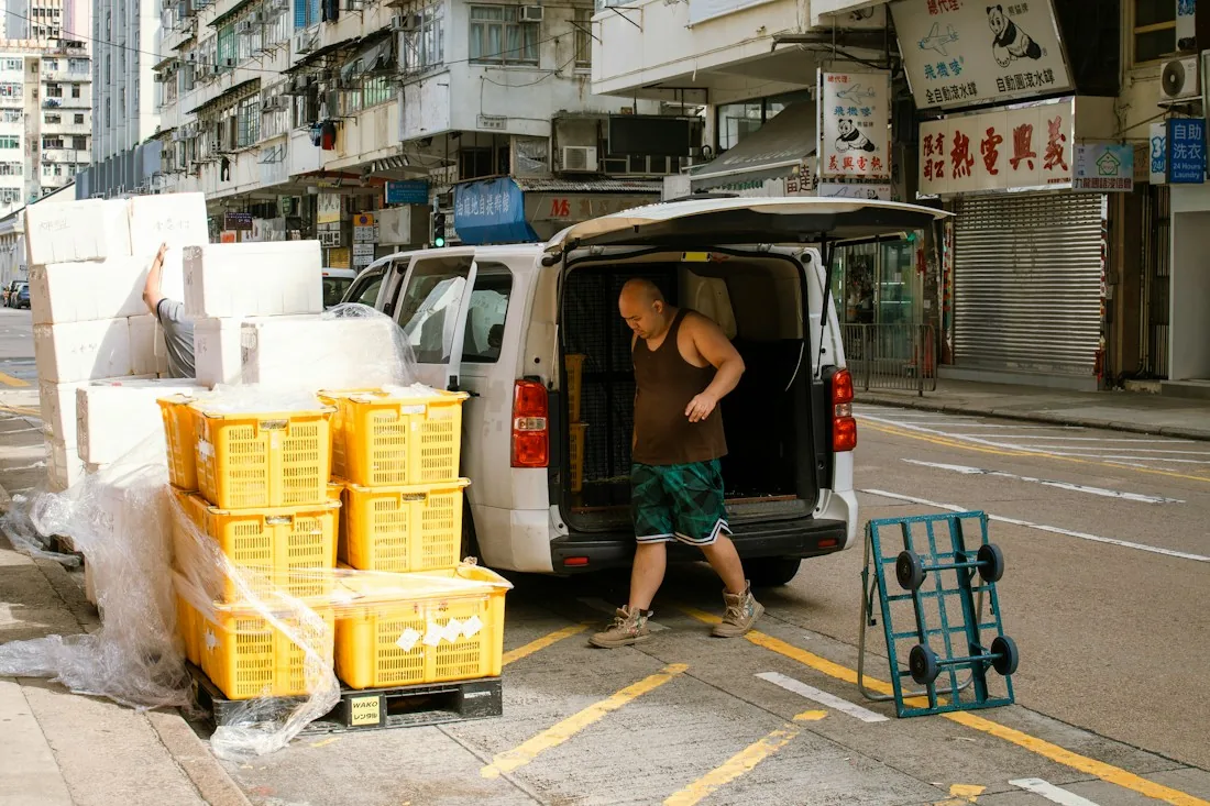 Crates being unloaded from a delivery van