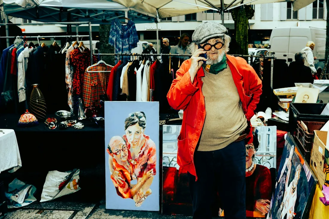 Trader using a mobile phone at a market stall
